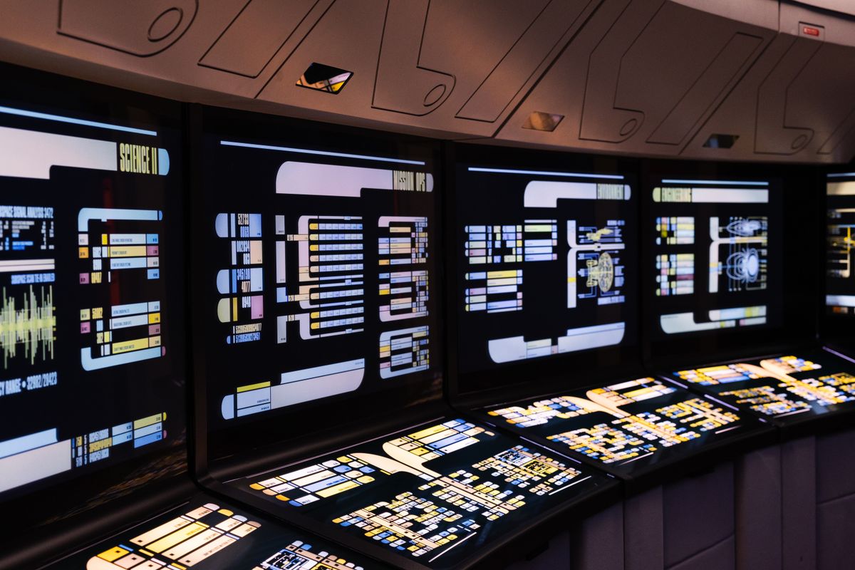 Control room with monitoring dashboards and data screens